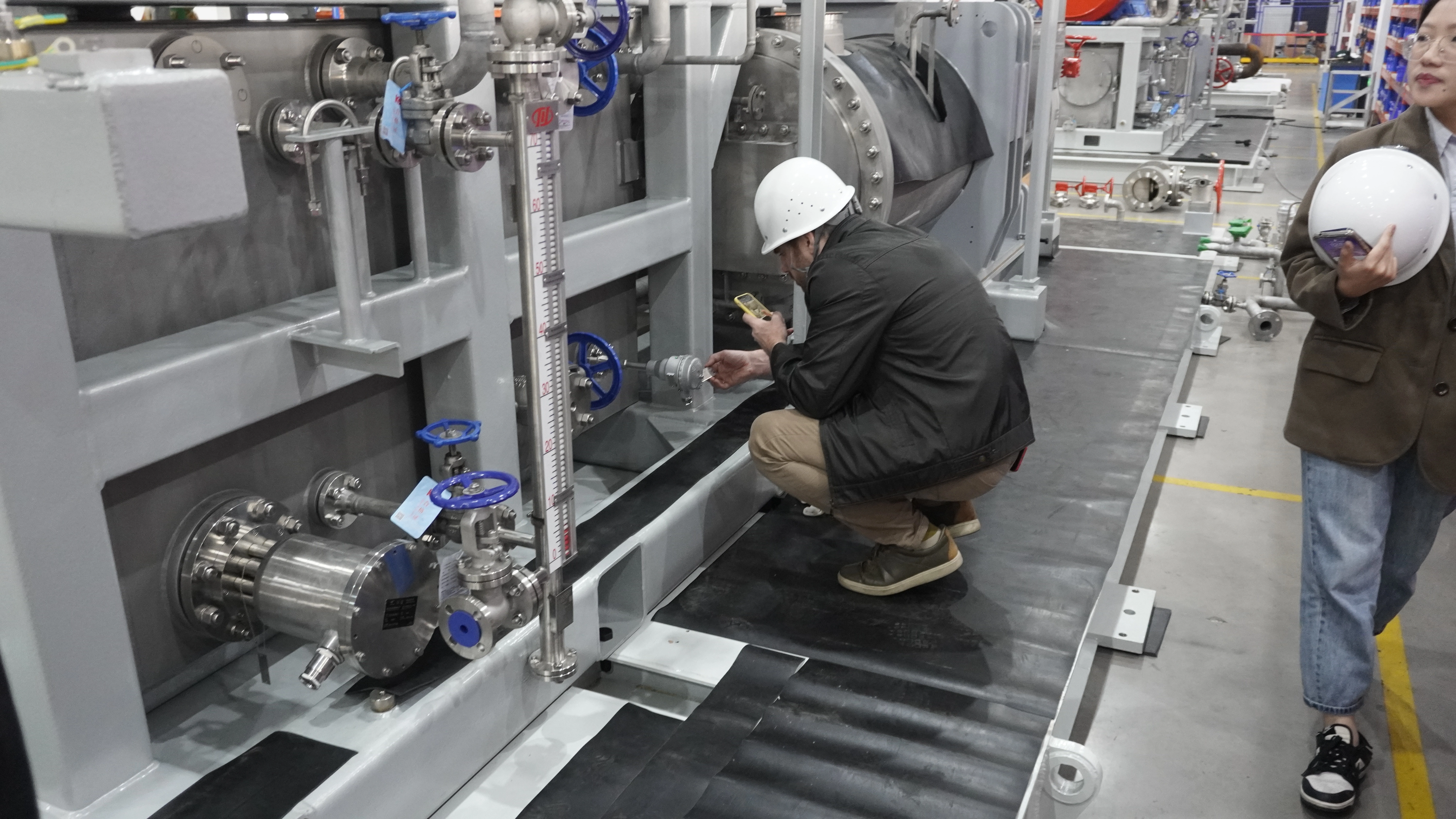 International machinery buyer reviewing production and testing capability during a factory visit in China